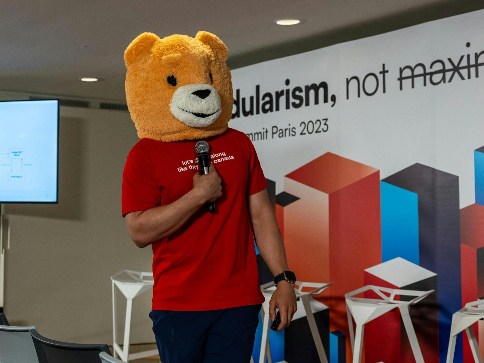 With bear costume and all, one of the founders of Berachain (DevBear) speaks at the Modular Summit in Paris, France during July of 2023. (Image Credit: Celestia via Celestia Twitter)